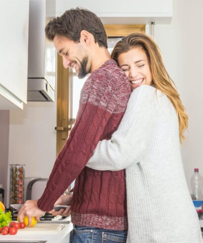 Loving couple cooking together in the kitchen at home